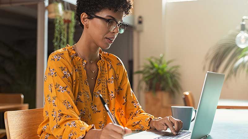 Student at desk writing
